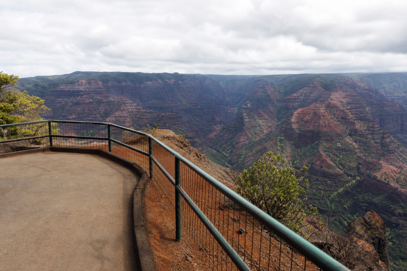 Older couple at a railed Waimea Canyon lookout a few steps from the parking area